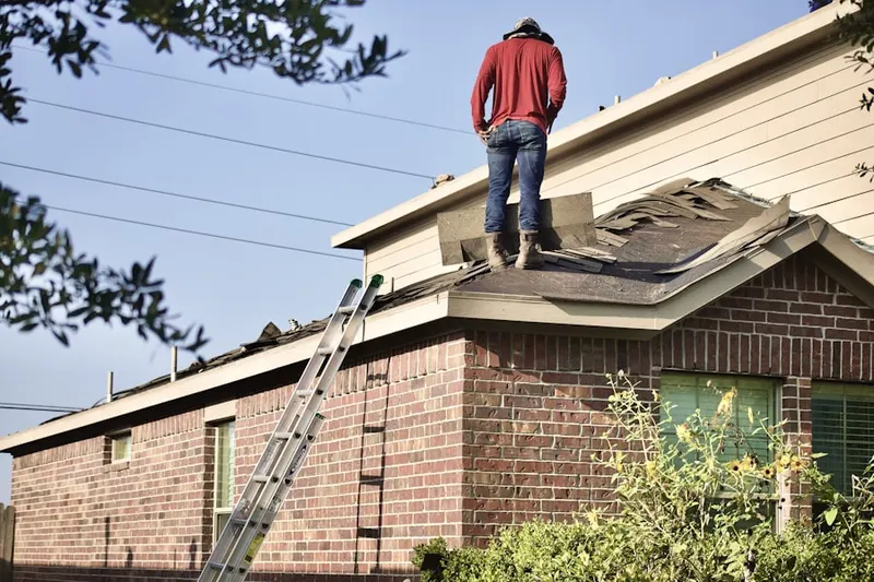 Professional roofer working on a residential roof in Kendalia